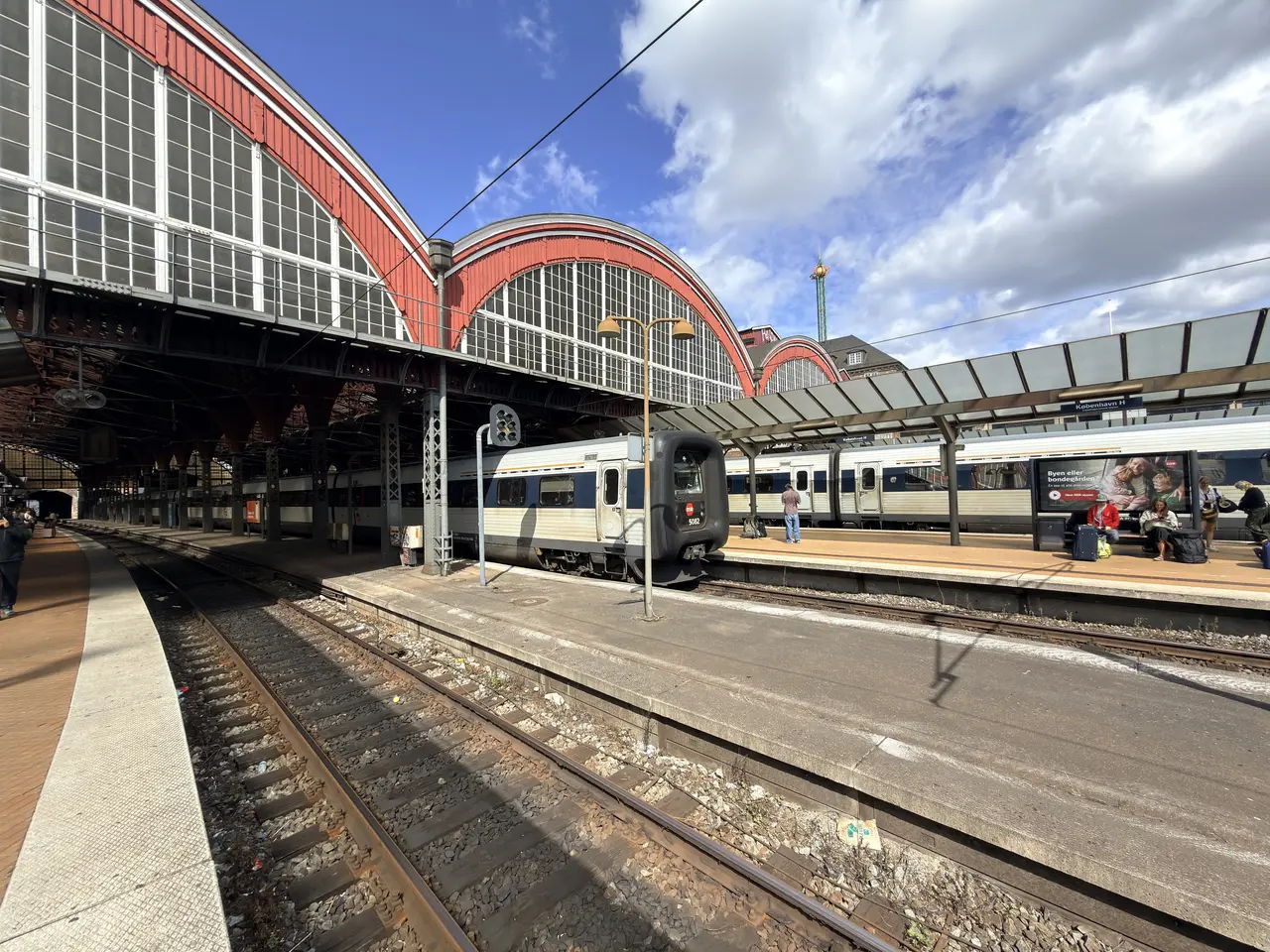 A run of platform hall arches receding down the platform, with rooflights above.