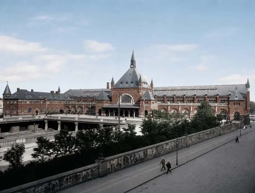 The station's long facade from above, the forecourt carried over a track cutting, with a stone balustrade in the foreground.