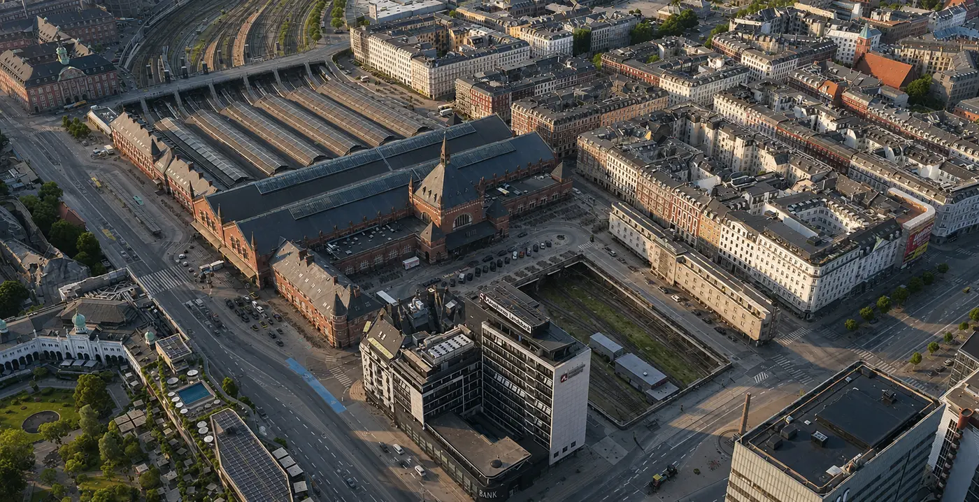 The station high from the north-east: the forecourt and entrance block in front, and behind it the six platform halls running away toward the tracks.