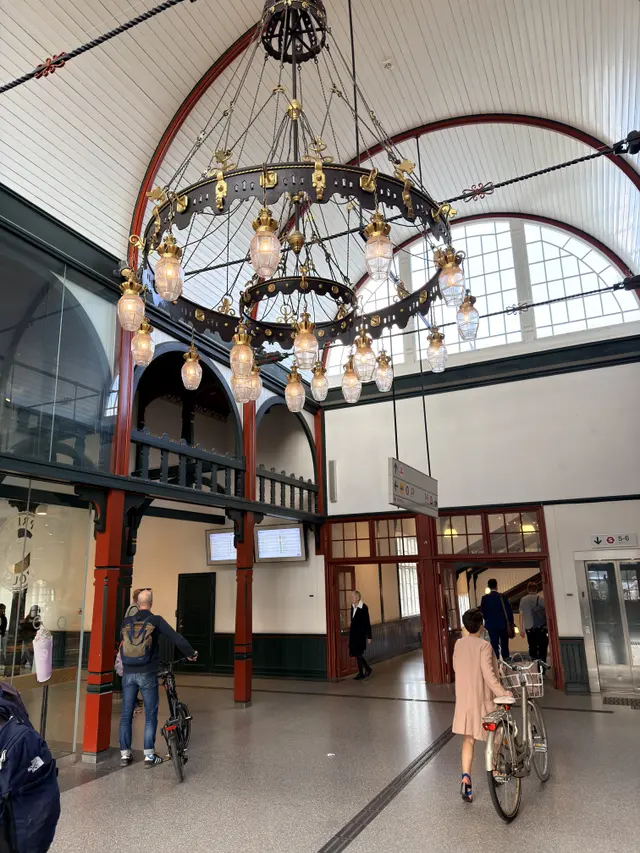 One of the two great halls: a curved white boarded ceiling ribbed in red, two-storey arcades and a large iron chandelier.