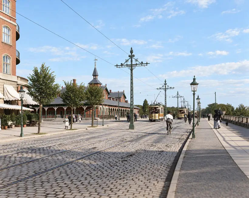 Østerport Station stands beside tram tracks, overhead wires, street lamps, pedestrians, cyclists and two approaching trams.