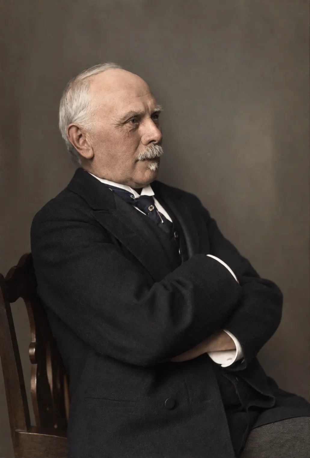 Portrait of Heinrich Wenck at seventy, white-haired, seated with arms folded.