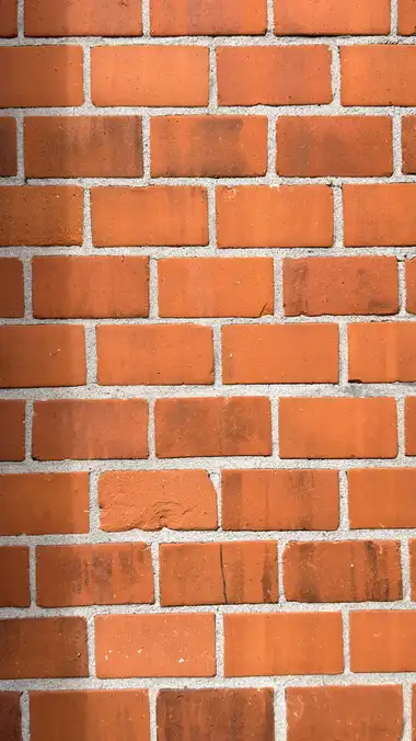 Detaljefoto af rød tegl mørtel mur udvendigt på bygningen, i tegl og mørtel.