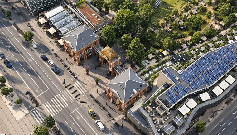 Indgangsrækken set skråt oppefra over Vesterbrogade: en pavillon med gråt valmtag forrest, porten med kuppel bagved og haven længere væk.